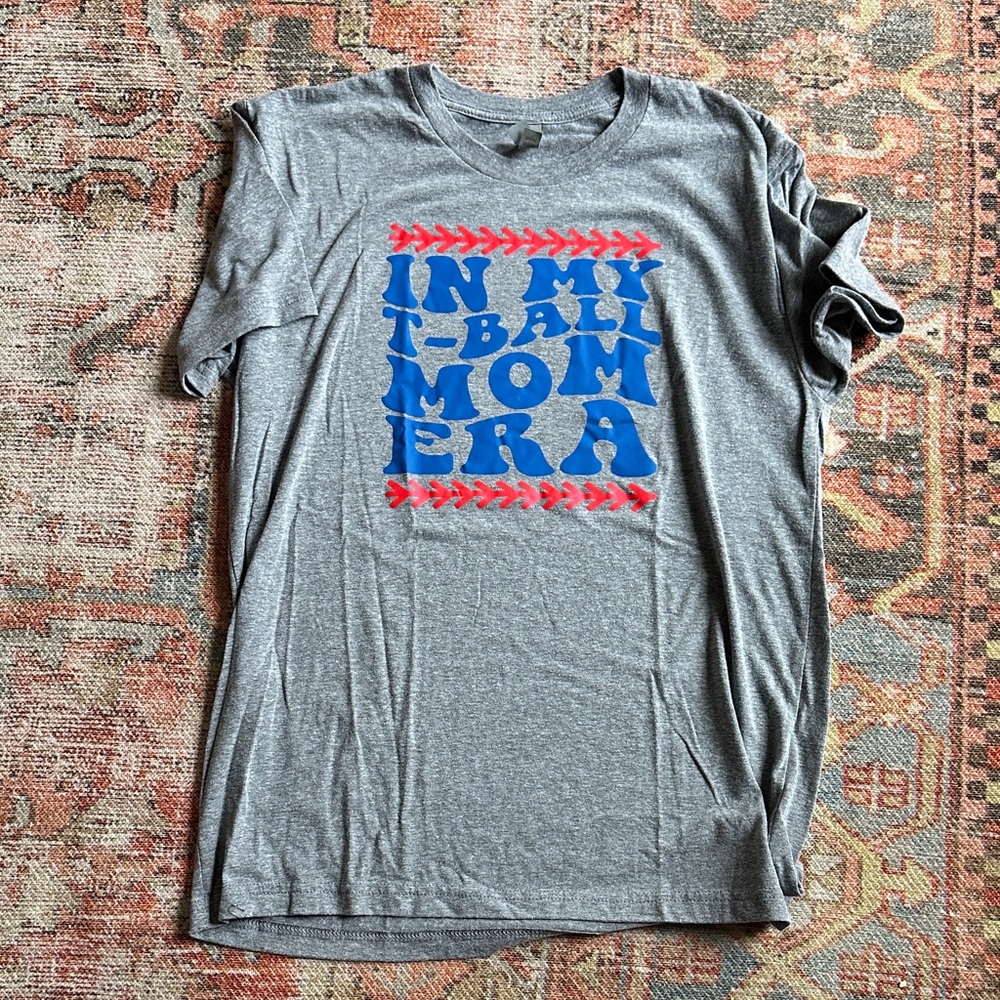 Next Level Apparel Gray Tee with Blue Logo and Red Stitch Graphic